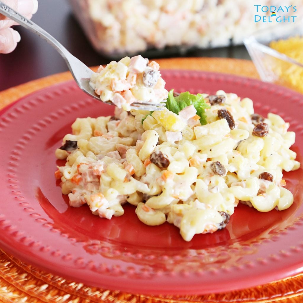 Digging in the macaroni salad with a fork.