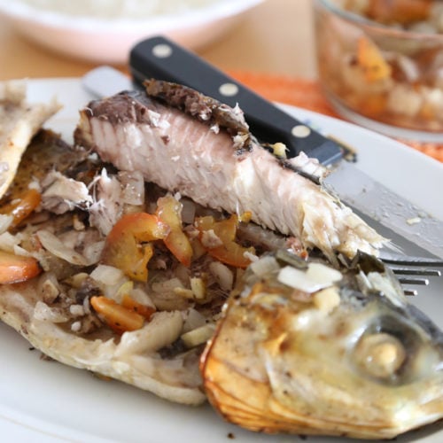 Inihaw na bangus with and body stuffed with tomato and onion.