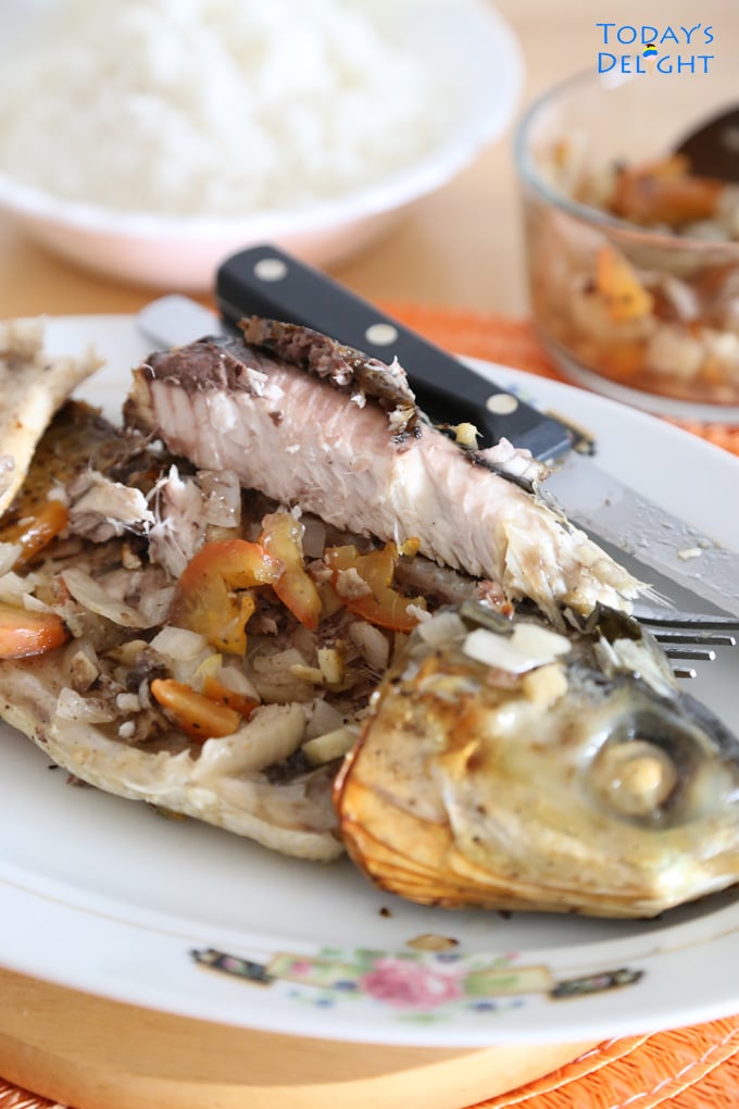 Inihaw na bangus with and body stuffed with tomato and onion.
