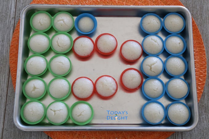 White rice cakes (puto calasiao) in the molds on a tray.