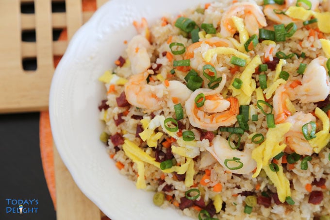 Yang chow fried rice with shrimp, scrambled eggs and vegetables on a half platter.