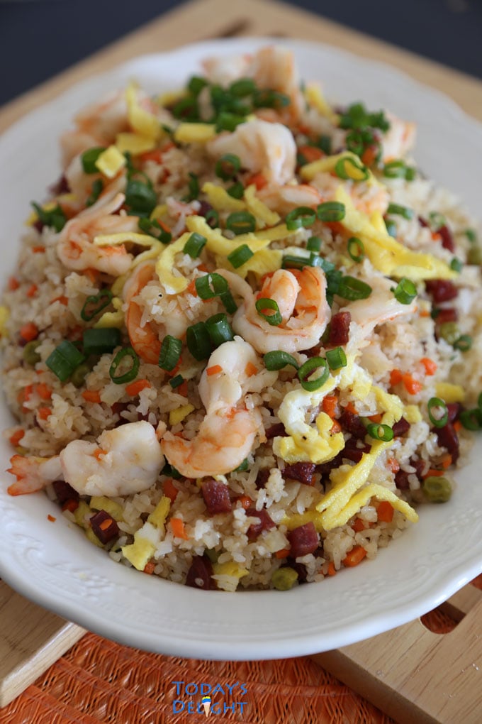 Yang chow fried rice with shrimp, scrambled eggs and vegetables on a platter.
