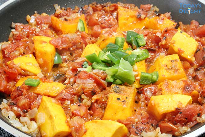 Kabocha squash and other ingredients in pan.