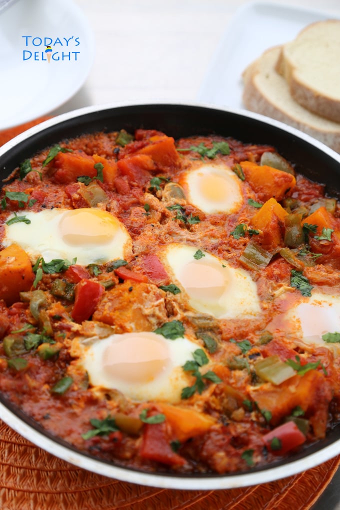 Kabocha Squash Shakshuka in a pan with poached eggs.