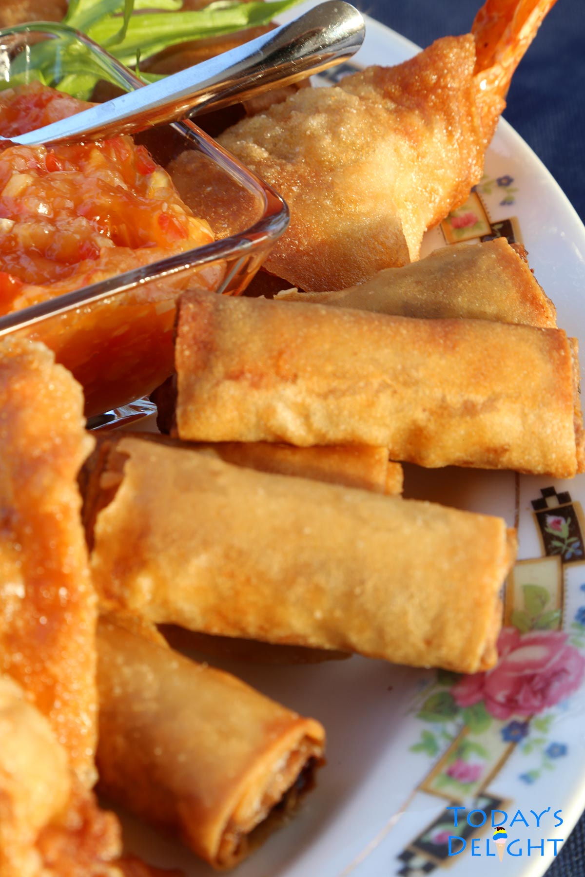 Platter of Filipino finger food including lumpiang shanghai.