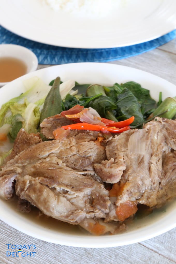 Filipino pork and vegetable soup flavored with powdered guava mix in a bowl.