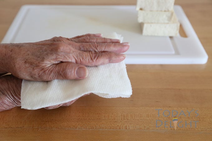 place paper towel under and above tofu