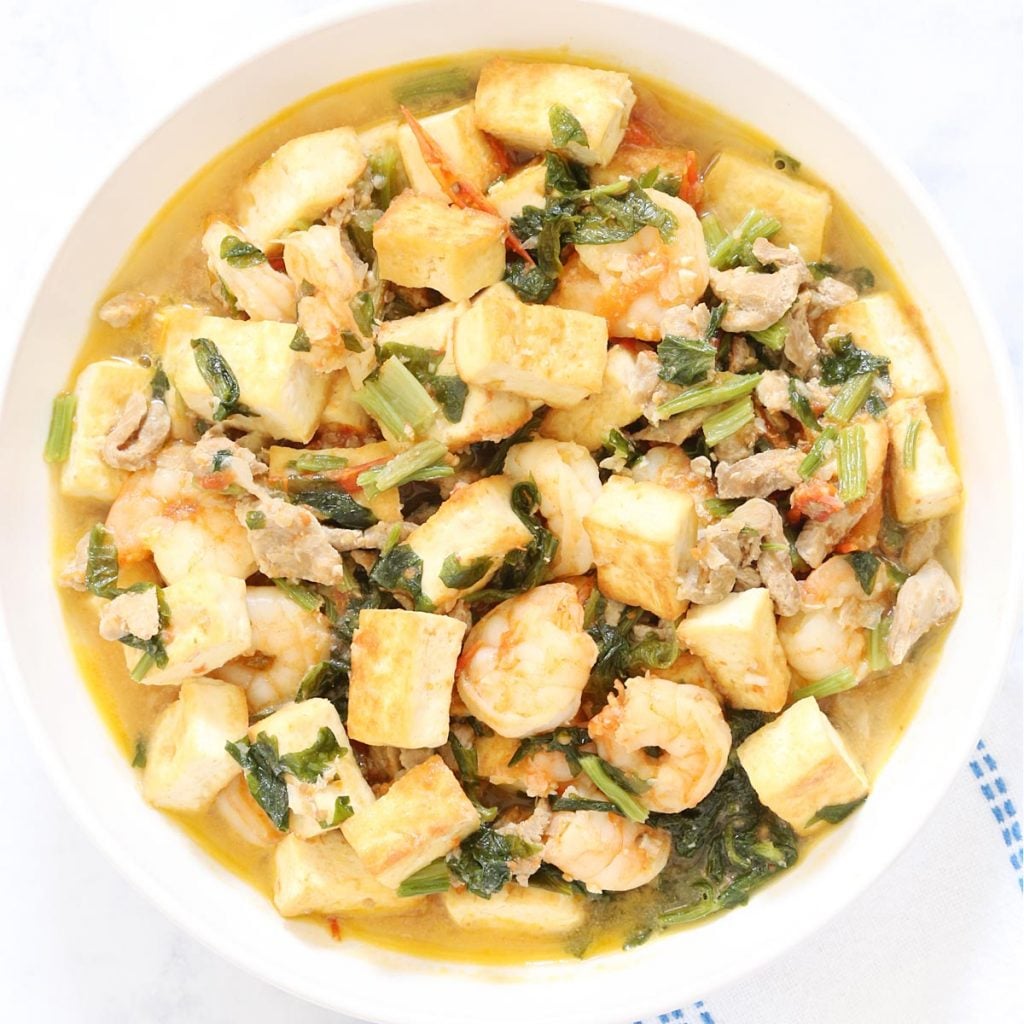 Chinese celery with tofu and shrimp stir fry in a dish.