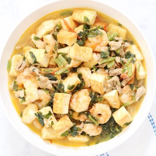 Chinese celery with tofu and shrimp stir fry in a dish.