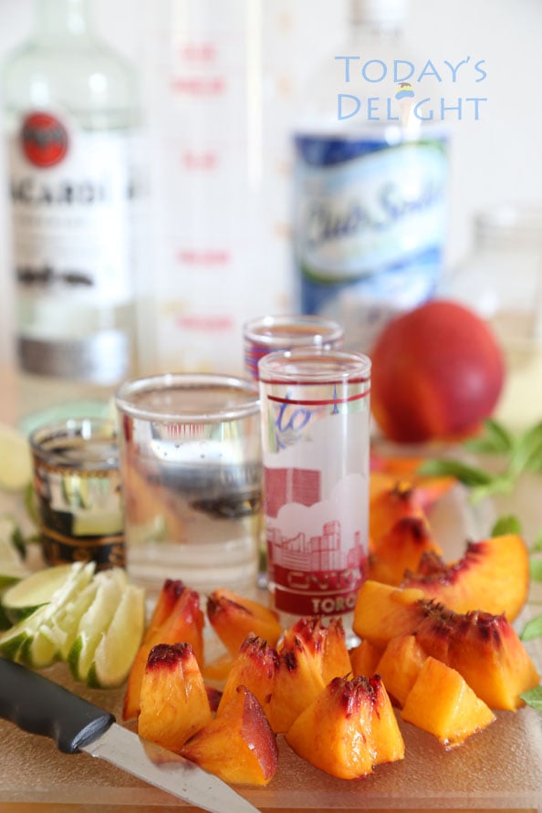 Mojito ingredients, slices of lime, nectarines, rum and club soda.