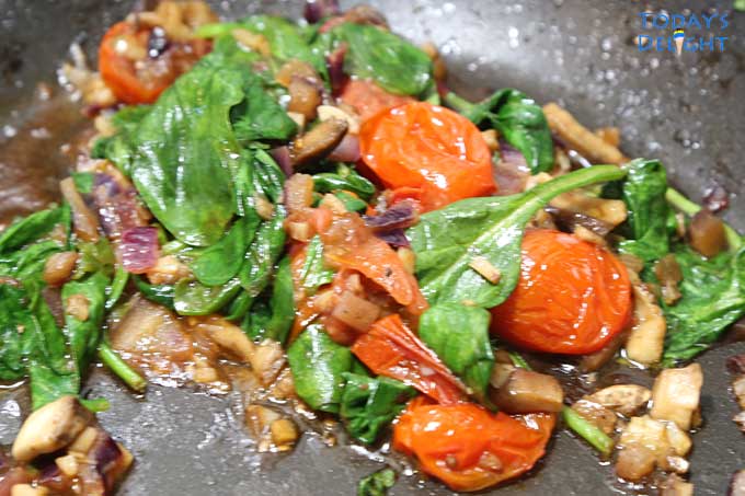 Sauteing spinach, tomatoes & other vegetables.