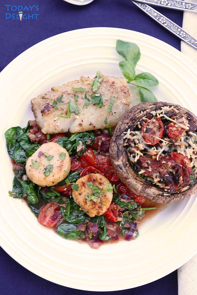 Scallops, cod fish and mushroom in spinach and tomatoes.