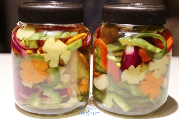 Two bottles of pickled bitter gourd (ampalaya atchara) mixed with other vegetables.