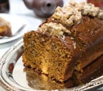 Slice pumpkin bread with frosting on top.