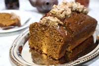 Slice pumpkin bread with frosting on top.