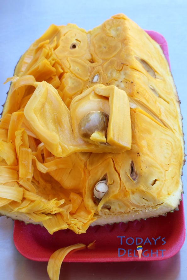 Half of a jackfruit showing the seed of one of the fruit.