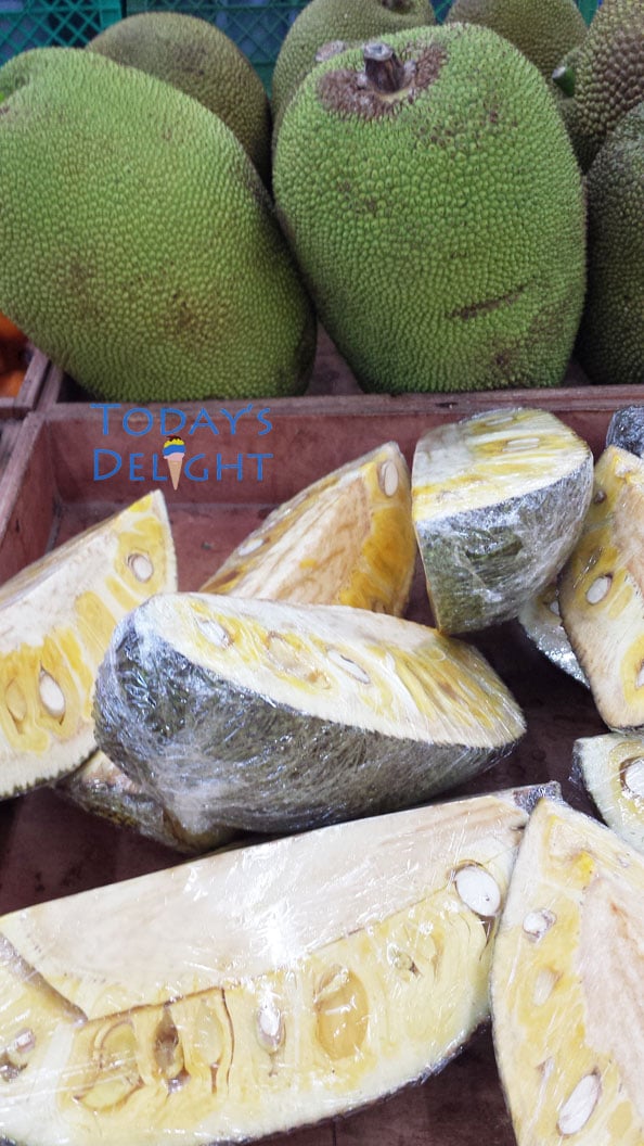 Whole jackfruits and pieces wrapped in plastic sold in Asian stores.
