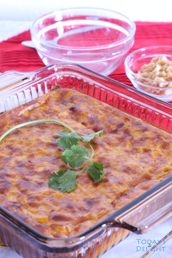 Easy baked corn casserole in glass baking pan garnished with parsley.