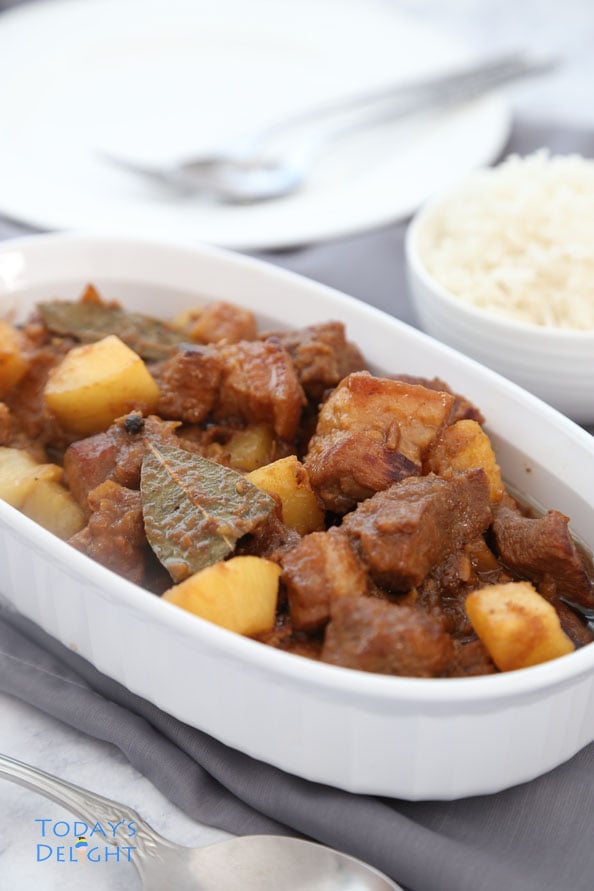Pork hamonado recipe is a Filipino stew with pork and pineapple in a platter with a side of white rice.