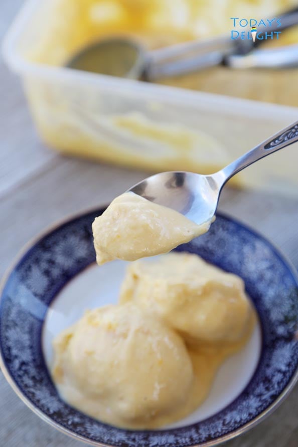 Creamy mango ice cream in a spoon is Today's Delight.