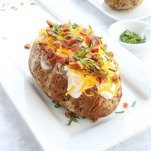 Bake potato with sour cream and toppings like cheese, bacon and chives.