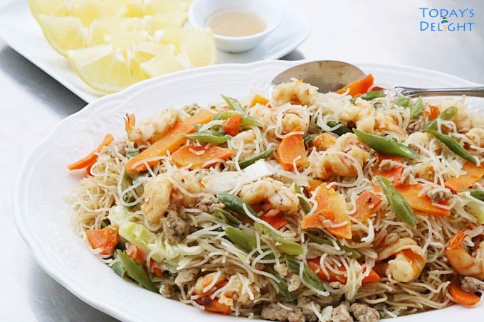 Pancit Guisado served with lemon and fish sauce.