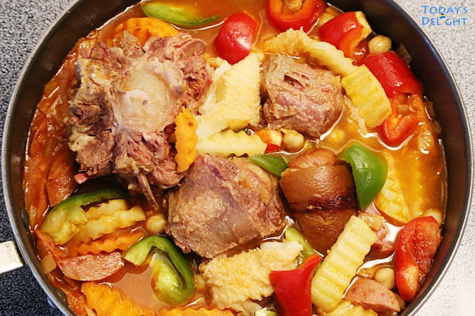 Filipino Callos with Oxtail and Tripe is a stew with garbanzos, potatoes, green and red pepper in sauce.