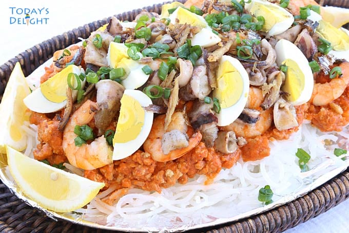 Filipino Noodle Dish topped with shrimp gravy and garnish