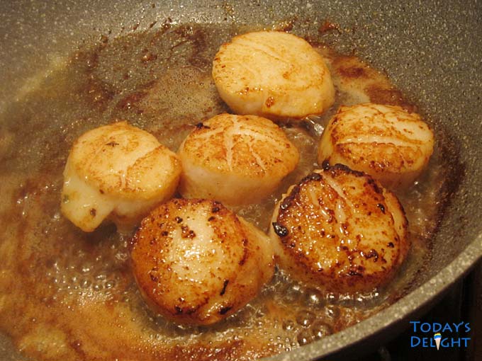 Seasoned scallops seared in butter.