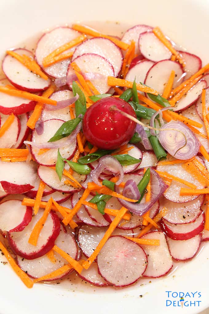 Asian salad with carrot, radish, green onion, and shallot in sweet savory sauce.