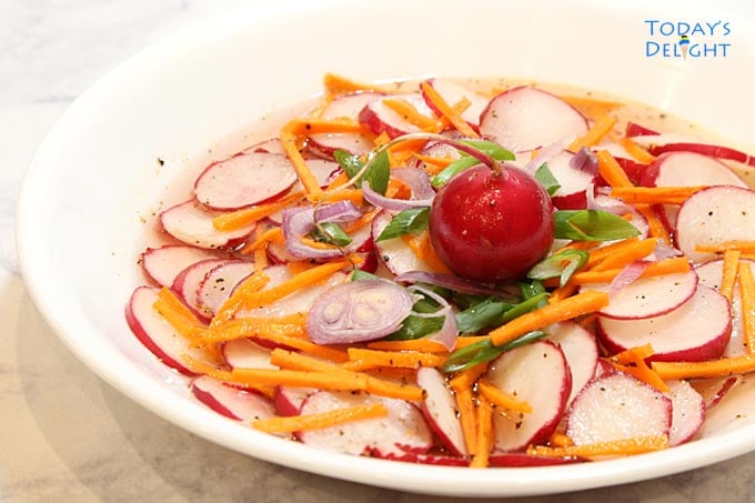 Asian salad with carrot, radish, green onion, and shallot in sweet savory sauce.