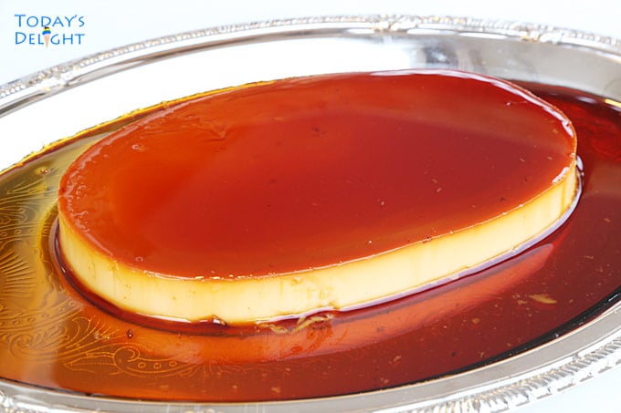 Filipino leche flan or custard flan with caramel syrup on a platter.
