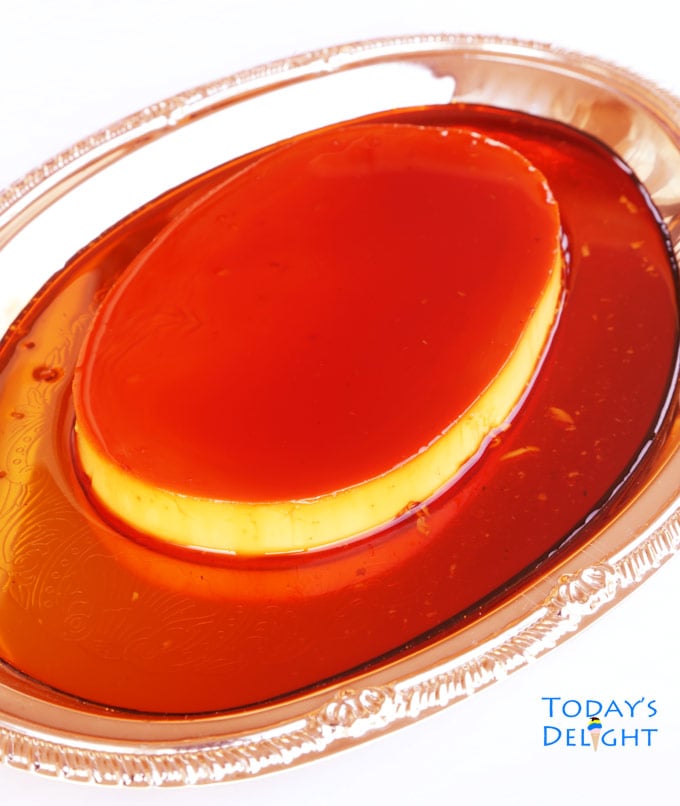 Filipino leche flan or custard flan with caramel syrup on a platter.