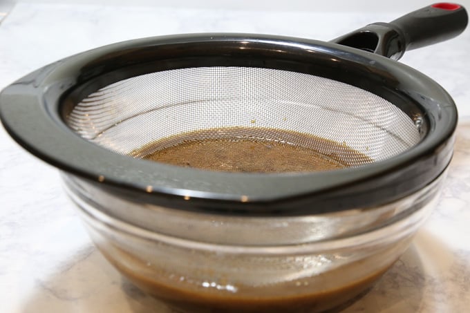 Straining sauce.