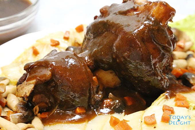 Plated Pata Tim (Braised Pork Hock) with vegetables & mushroom.
