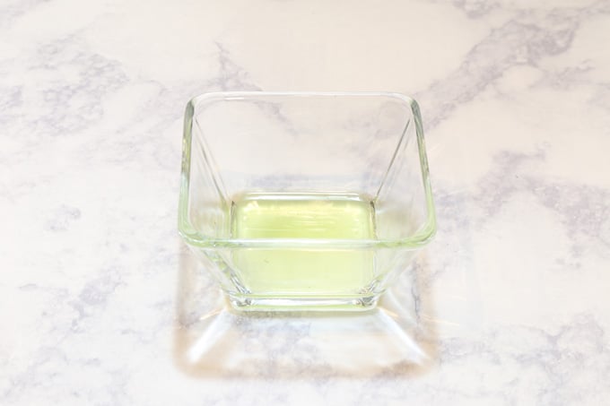 Lime flavor extract from lime leaves on a small glass container.