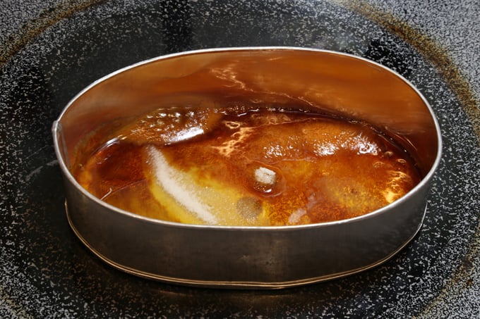 Caramelized white sugar in leche flan pan on stove top.