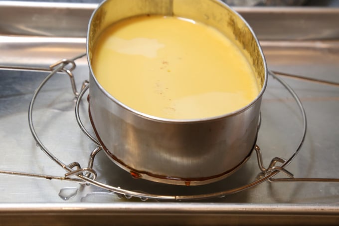 Cooling cooked flan on a trivet on a tray.
