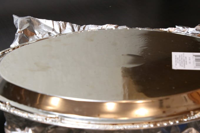 A platter is placed above the flan pan or mold to flip quickly to transfer flan.