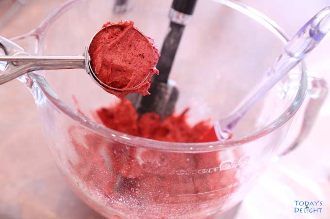 Red velvet batter in mixing bowl.