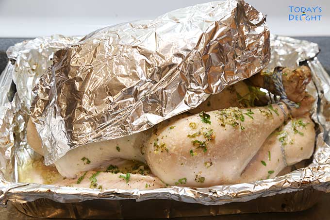 Turkey breast covered with foil to prevent overcooking.
