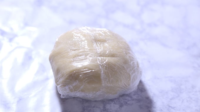 Eggnog Custard Pie crust wrapped in plastic.
