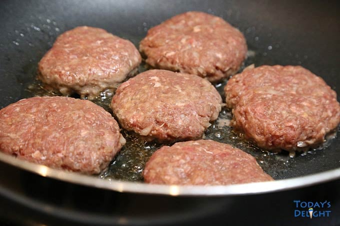 Frying burger patties.