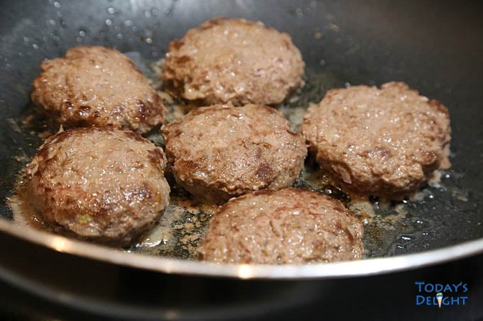 Patties slightly fried in pan.