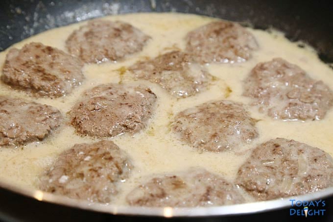 Burger patties simmered in gravy.