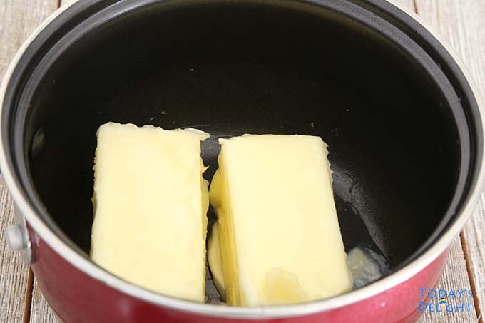 Melting two sticks of butter in sauce pan.