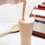 Smoothie poured in tall glass.