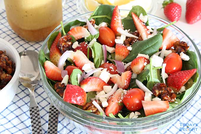 Strawberry Spinach Salad with dressing, lemon, candied walnuts on the side.