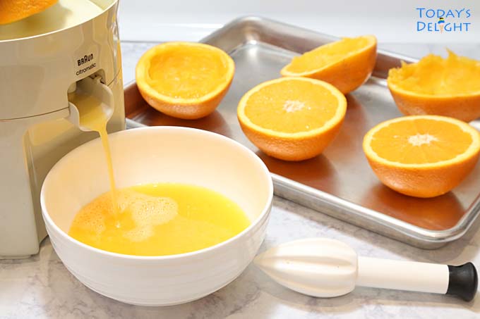 Oranges in a juicer.