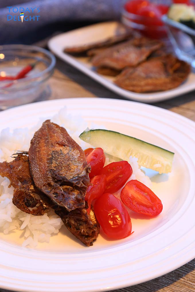 Fried danggit fish is served with rice and vegetables.